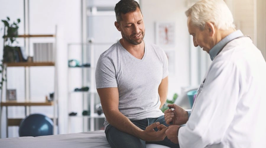 Doctor treating a man showing show acne treatments help alcohol-Induced acne