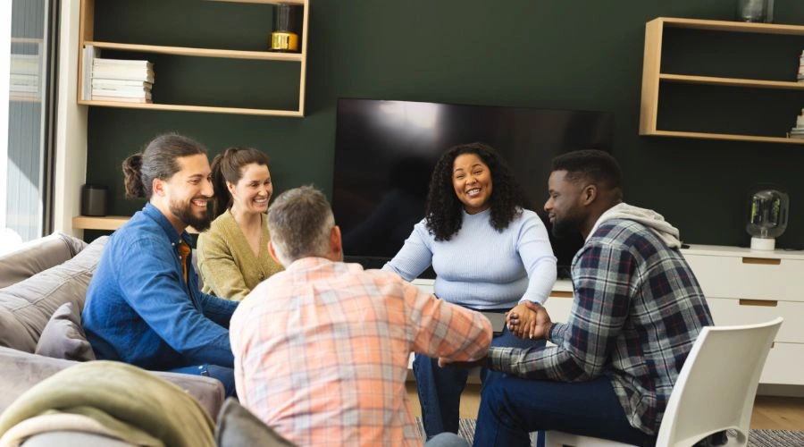 Group discussion at a table displaying how Every Topic Is a Chance to Heal