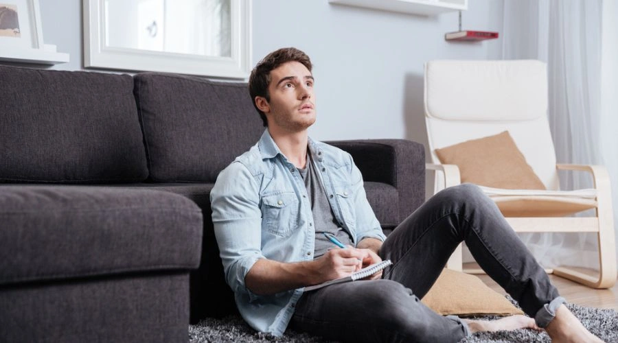 Man with notebook writing Moral Inventory