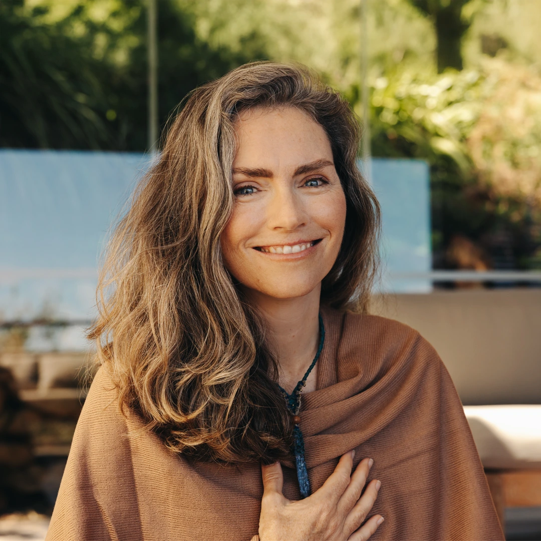 Smiling woman with hand over her heart, symbolizing hope, healing, and substance use treatment covered by insurance at Changes Healing Center in Arizona.