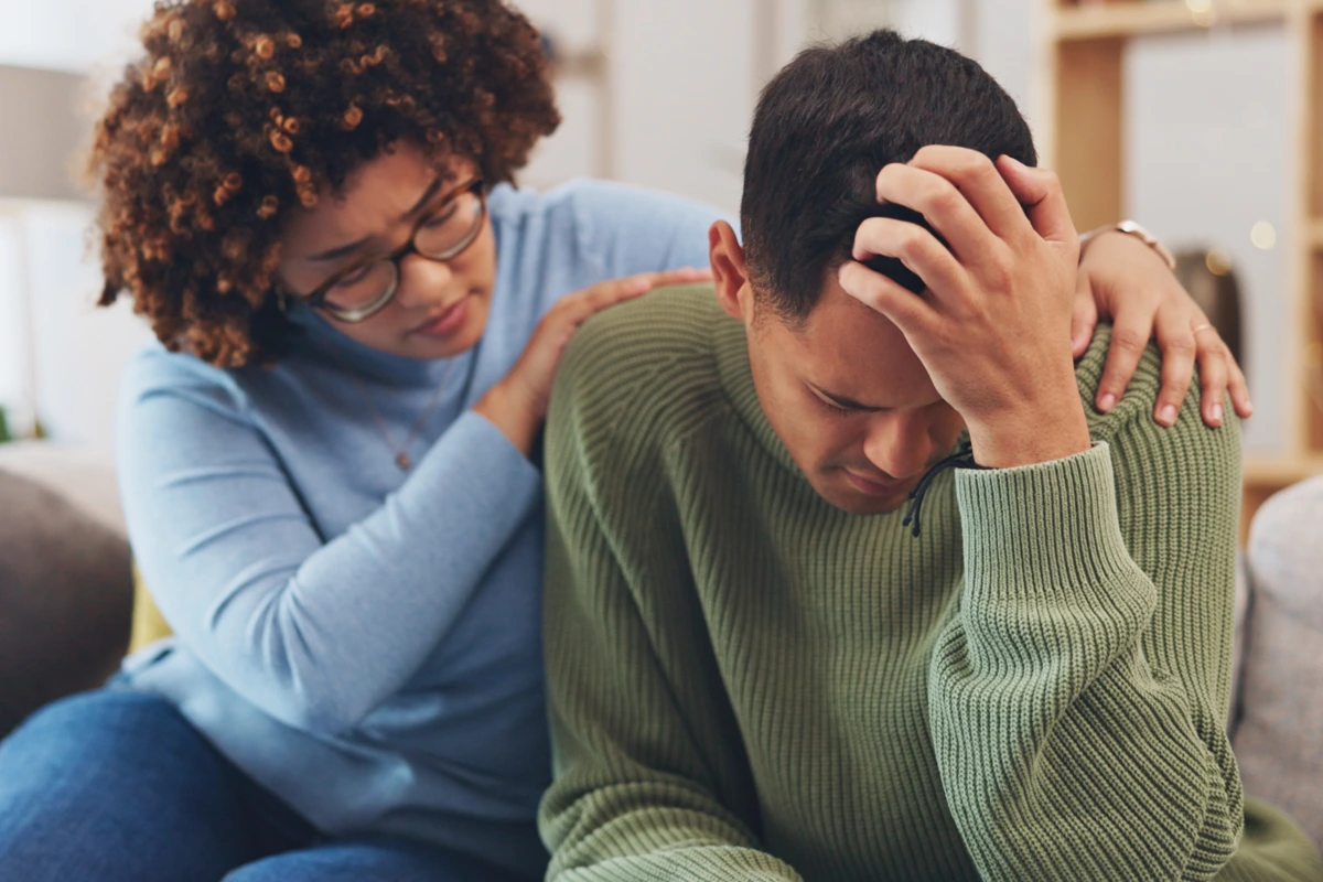 Man receiving comfort and support during a moment of anxiety, representing mental health treatment covered by insurance at Changes Healing Center.