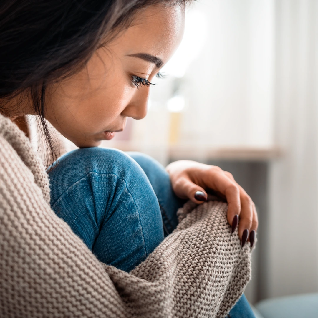 Young woman sitting in reflection, symbolizing the emotional toll of fentanyl addiction and the importance of compassionate treatment in Phoenix, Arizona.