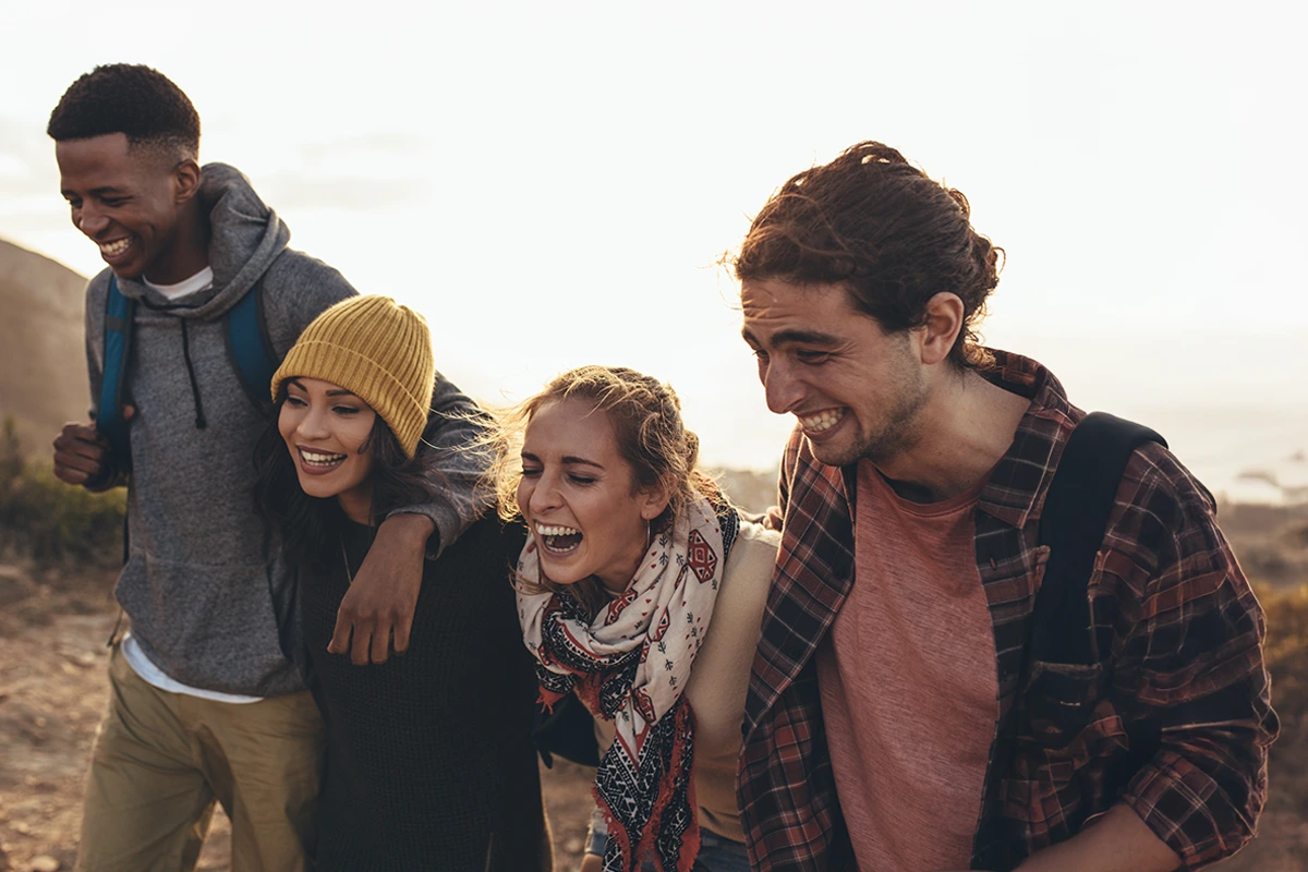 Friends smiling outdoors—peace of mind after understanding insurance coverage.