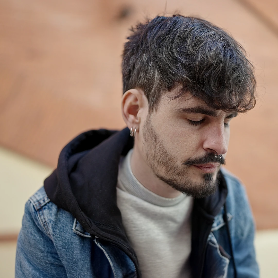 Young man with eyes closed and thoughtful expression, reflecting on the struggles of Xanax addiction and the importance of seeking help.