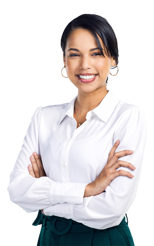 Smiling professional woman standing confidently with arms crossed, wearing a white blouse and green slacks, symbolizing confidence and compassionate care.